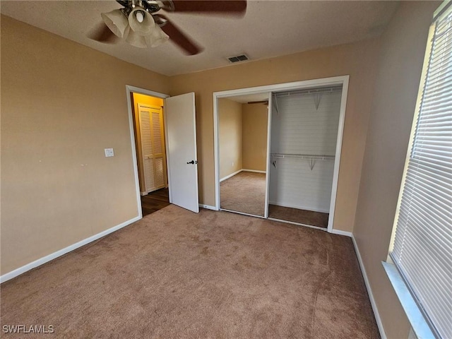 unfurnished bedroom featuring carpet flooring, ceiling fan, and a closet