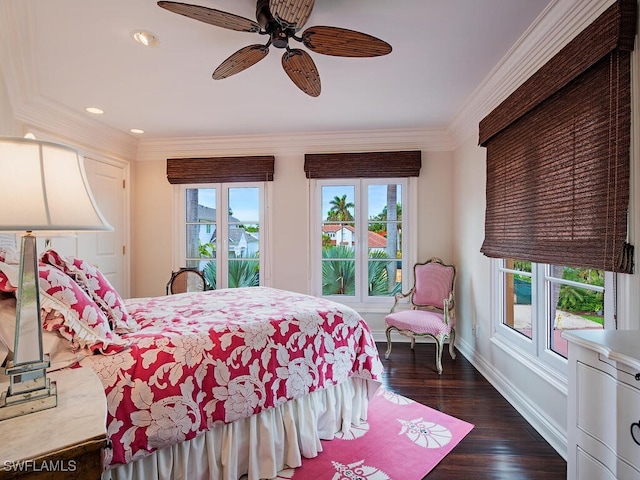 bedroom featuring dark wood-type flooring, ceiling fan, and ornamental molding