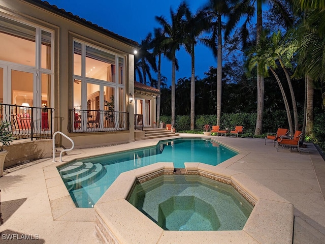 view of pool with an in ground hot tub and a patio area