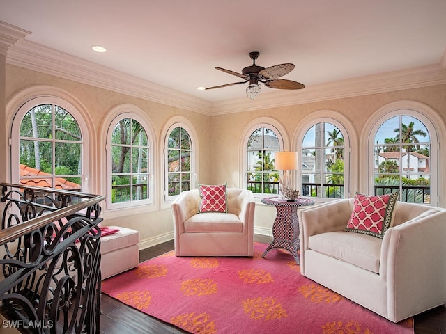 interior space with ceiling fan, hardwood / wood-style flooring, and crown molding