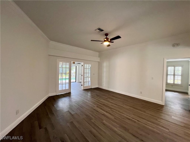 spare room featuring french doors, crown molding, ceiling fan, and dark wood-type flooring