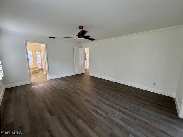 empty room featuring dark hardwood / wood-style flooring, ceiling fan, and ornamental molding