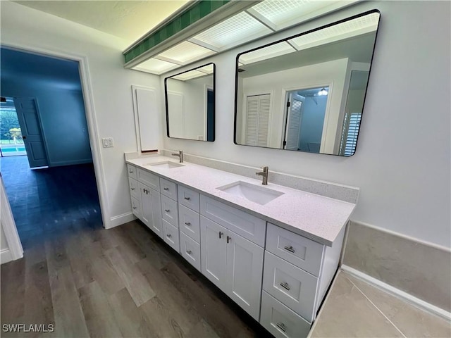 bathroom with hardwood / wood-style floors and vanity