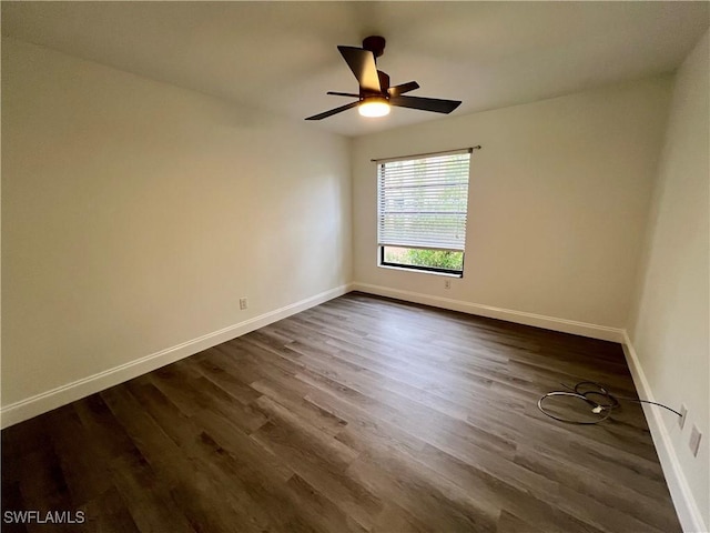 spare room with dark hardwood / wood-style floors and ceiling fan