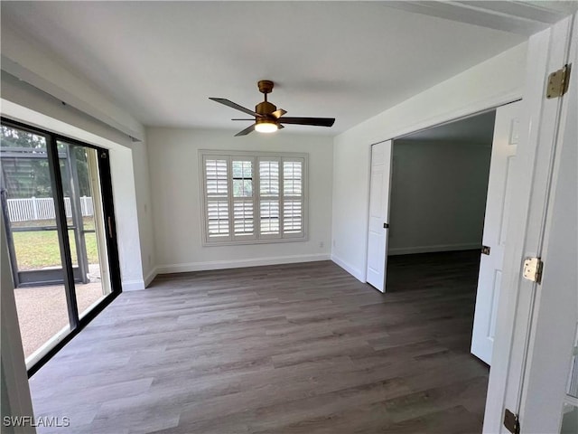 spare room with hardwood / wood-style floors and ceiling fan