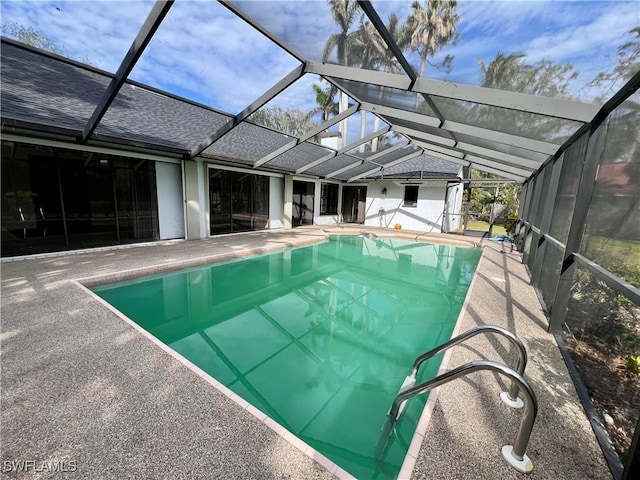 view of pool with a lanai and a patio