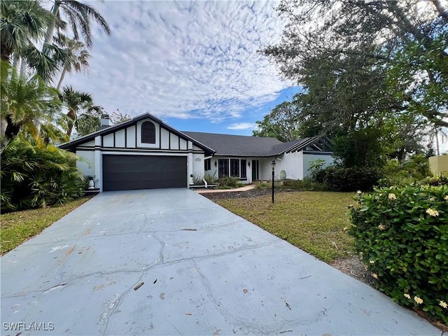 view of front of house with a front lawn and a garage