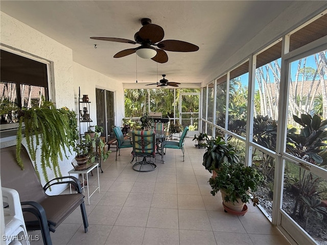 sunroom featuring ceiling fan