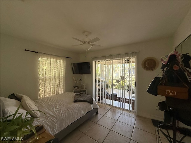 tiled bedroom with ceiling fan and access to outside