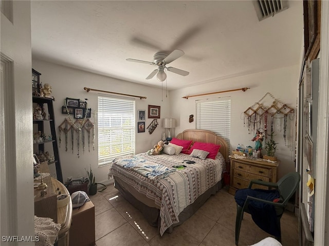 tiled bedroom with ceiling fan