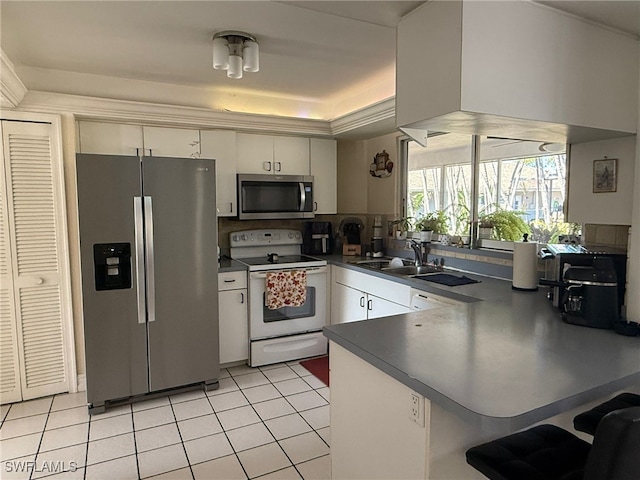 kitchen featuring kitchen peninsula, white cabinetry, stainless steel appliances, and light tile patterned floors