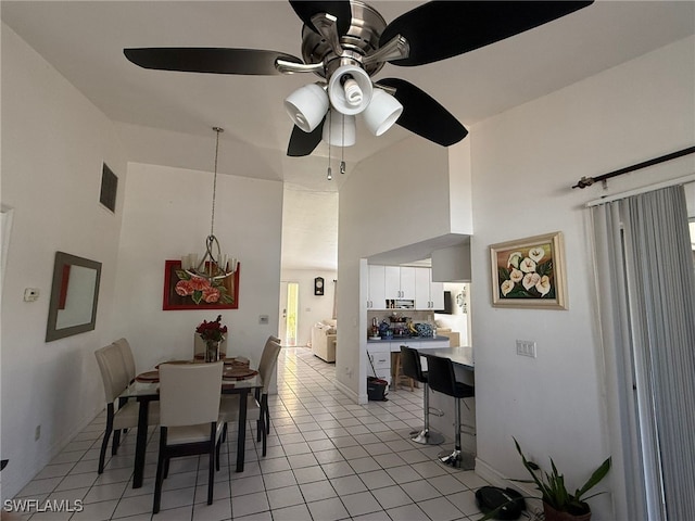 dining area featuring ceiling fan, high vaulted ceiling, and light tile patterned floors