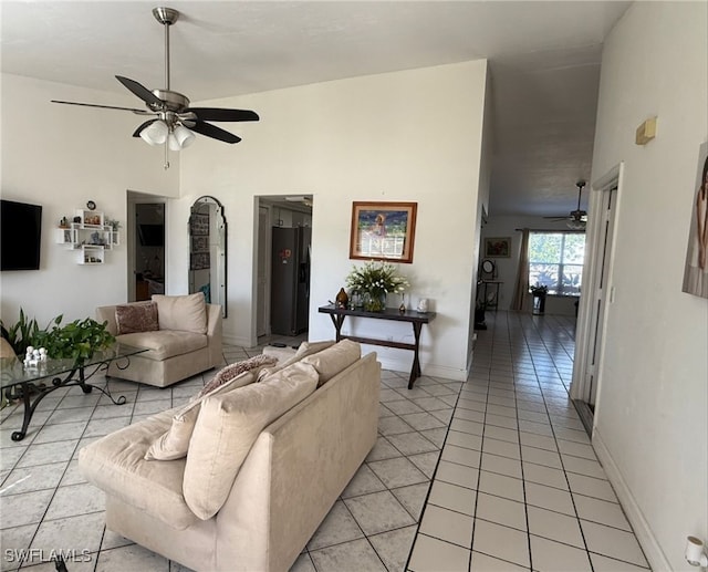 tiled living room with ceiling fan