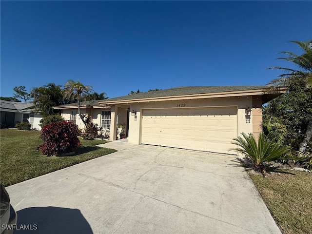 ranch-style house featuring a garage and a front lawn