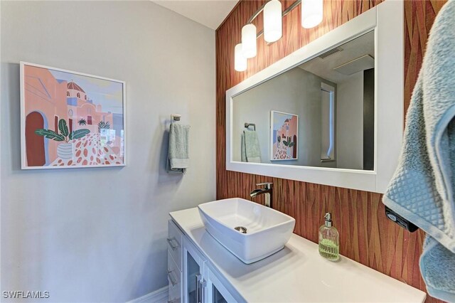 bathroom with wooden walls and vanity