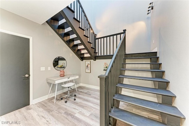 staircase with hardwood / wood-style floors