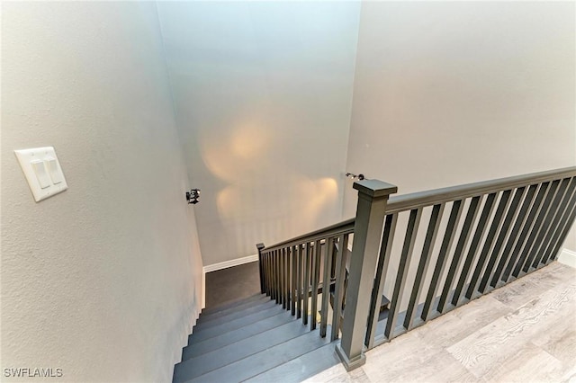 stairs featuring hardwood / wood-style floors