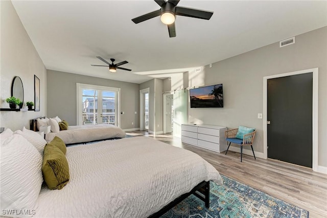 bedroom with ceiling fan, light hardwood / wood-style floors, and access to exterior