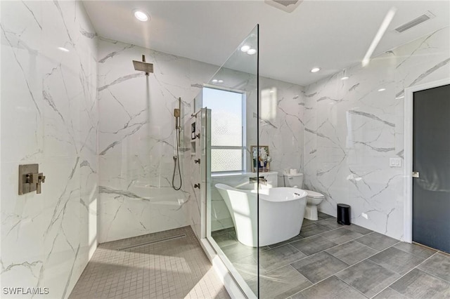 bathroom with tile walls and shower with separate bathtub