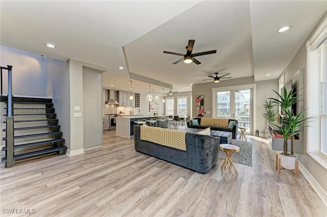 living room featuring light wood-type flooring and ceiling fan