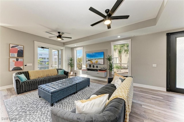 living room with light hardwood / wood-style flooring and ceiling fan