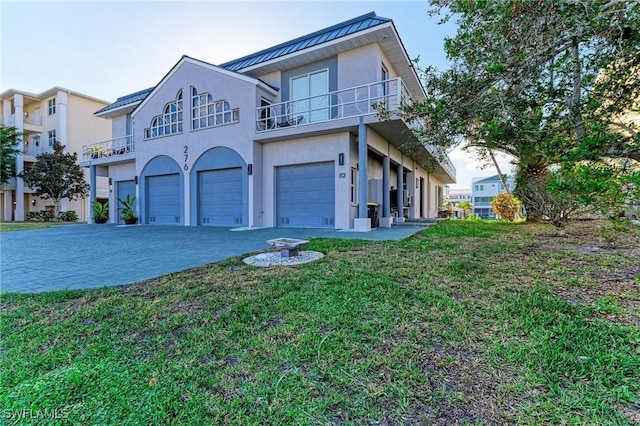 view of front of property featuring a garage and a balcony