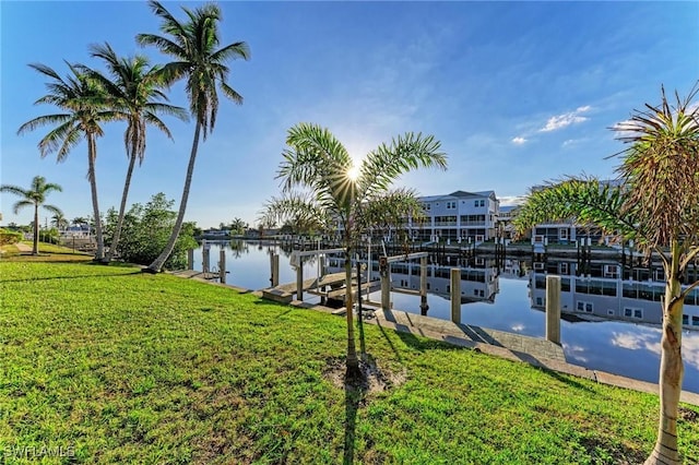 dock area featuring a lawn and a water view