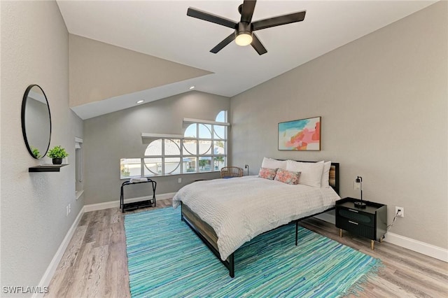 bedroom featuring ceiling fan, wood-type flooring, and lofted ceiling