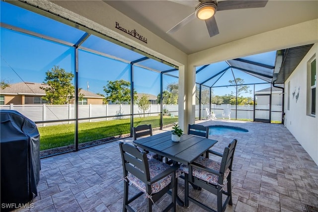 sunroom featuring ceiling fan and plenty of natural light