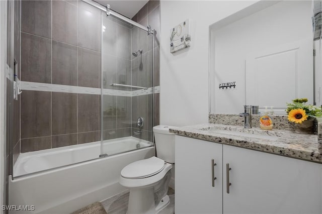 full bathroom featuring vanity, toilet, and bath / shower combo with glass door