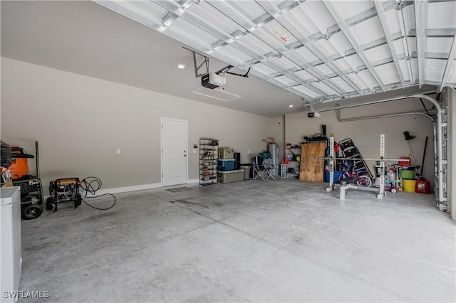 garage featuring electric water heater and a garage door opener