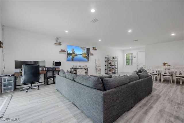 living room with light hardwood / wood-style flooring