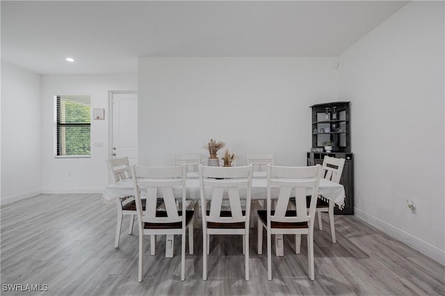 dining space with light hardwood / wood-style flooring