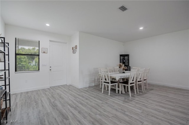 unfurnished dining area featuring light wood-type flooring