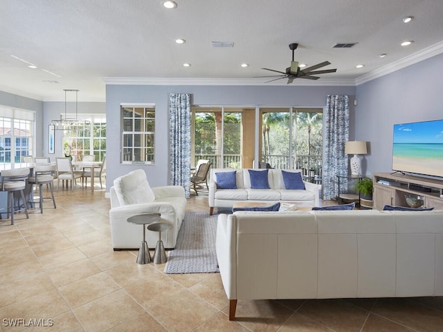 tiled living room featuring plenty of natural light, ceiling fan, and crown molding