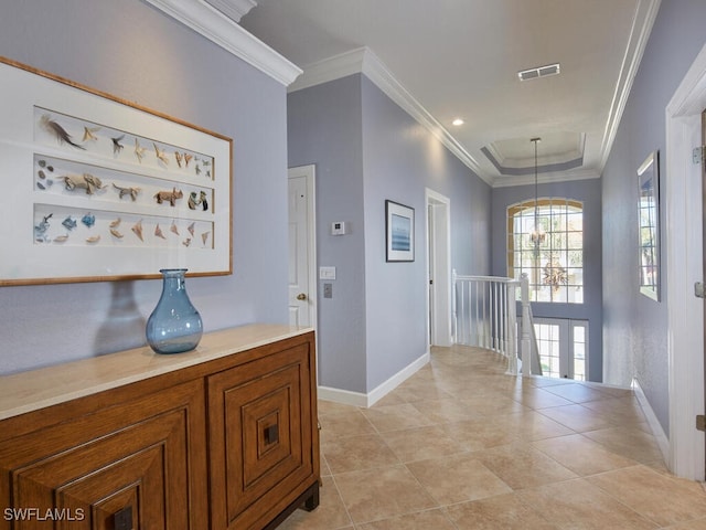 tiled foyer featuring ornamental molding and a chandelier