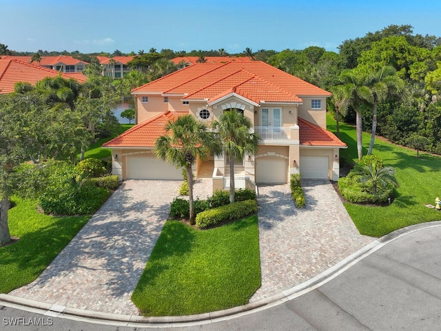 mediterranean / spanish house featuring french doors and a front lawn