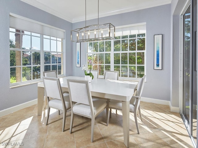 tiled dining space with ornamental molding and an inviting chandelier