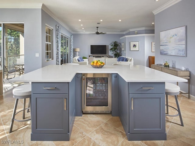 kitchen with wine cooler, a breakfast bar, and a kitchen island