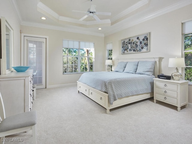 bedroom with a tray ceiling, ceiling fan, and ornamental molding