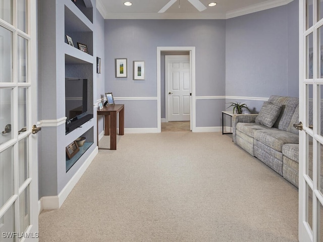 carpeted living room with built in features, ornamental molding, and french doors