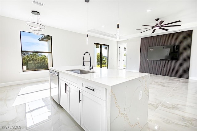 kitchen with white cabinets, sink, pendant lighting, a center island with sink, and dishwasher