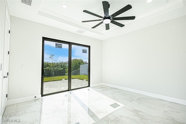 empty room featuring ceiling fan, a raised ceiling, and crown molding