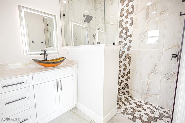 bathroom with vanity and tiled shower