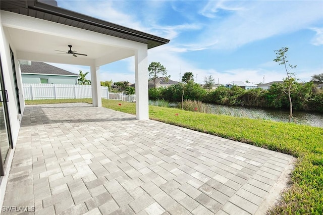 view of patio / terrace with a water view and ceiling fan