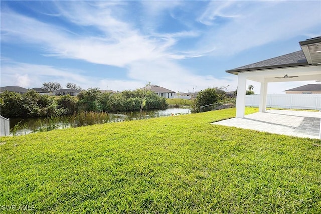 view of yard with a patio area and a water view