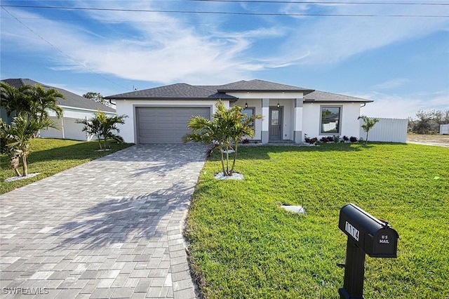 view of front of home featuring a front yard and a garage