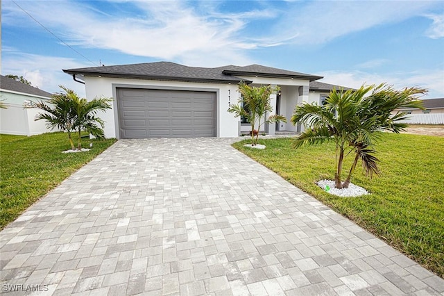 view of front of house featuring a front lawn and a garage