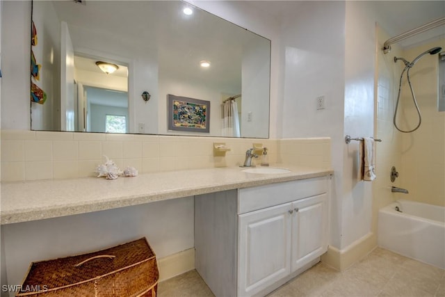 bathroom featuring vanity, tile patterned flooring, decorative backsplash, and tiled shower / bath