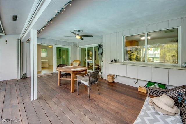 sunroom / solarium featuring ceiling fan